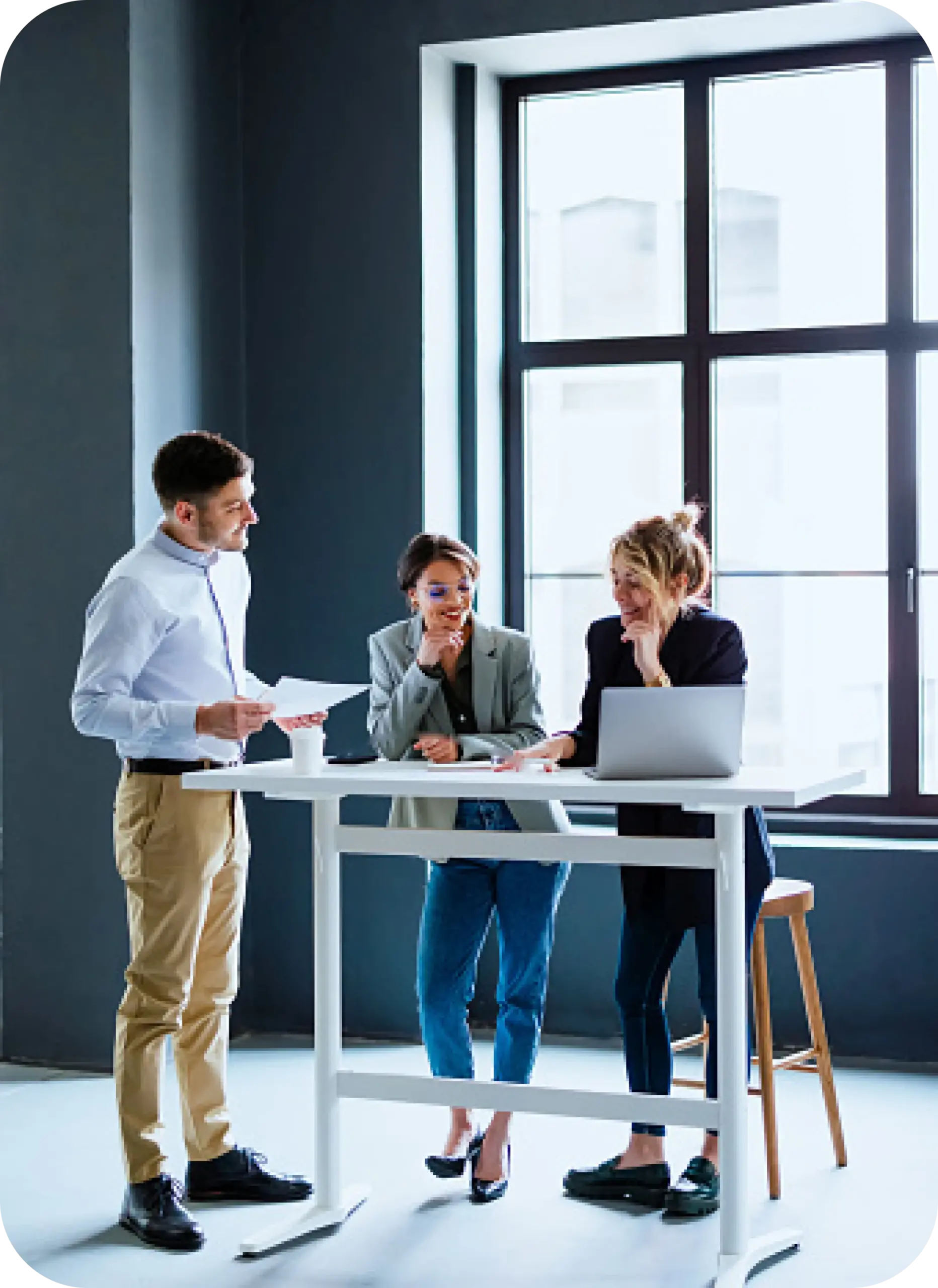 Three people working and talking at a table